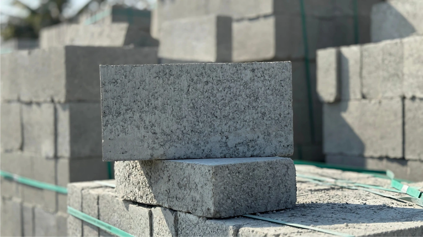 Bundled stacks of solid concrete blocks arranged for stock at Ashok Concrete